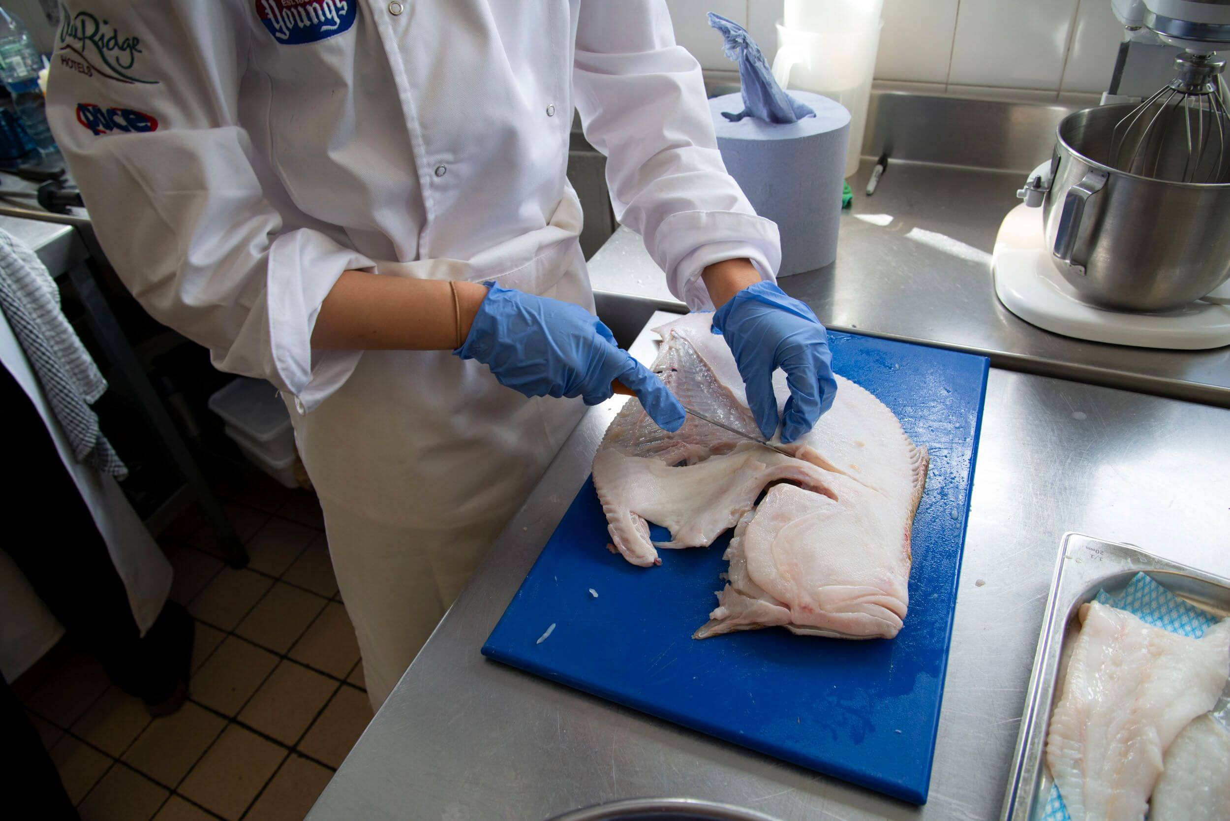 Chef filleting a flat fish